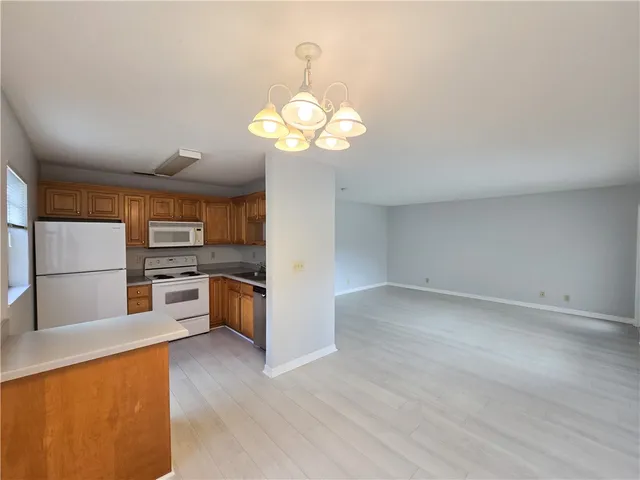 a view of a kitchen with a sink and a stove top oven