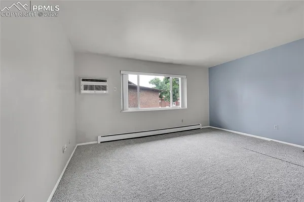 a kitchen with a white cabinets and wooden floor