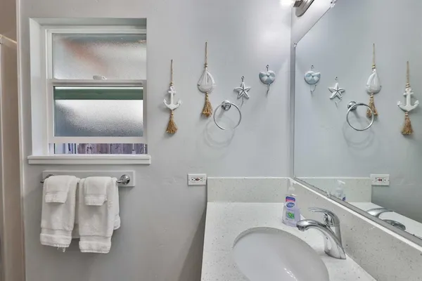 a bathroom with a sink vanity and mirror