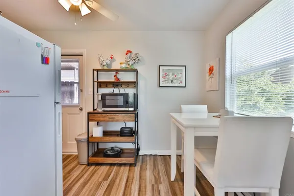 a view of dining room with wooden floor and window