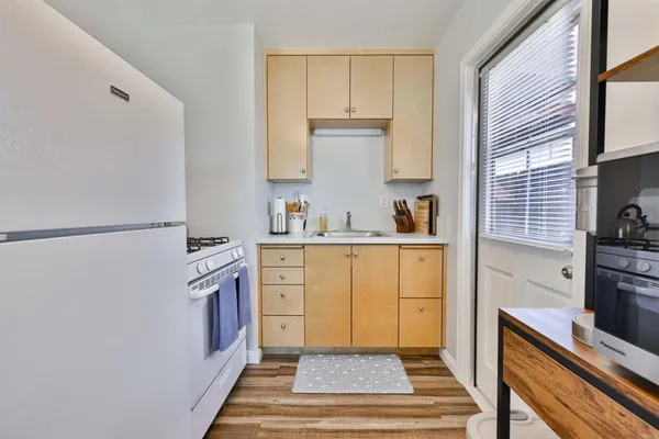 a kitchen with a refrigerator and a table