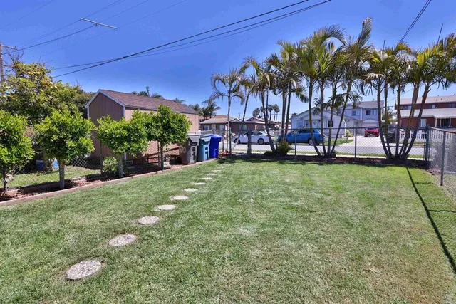 a view of an house with backyard and sitting area
