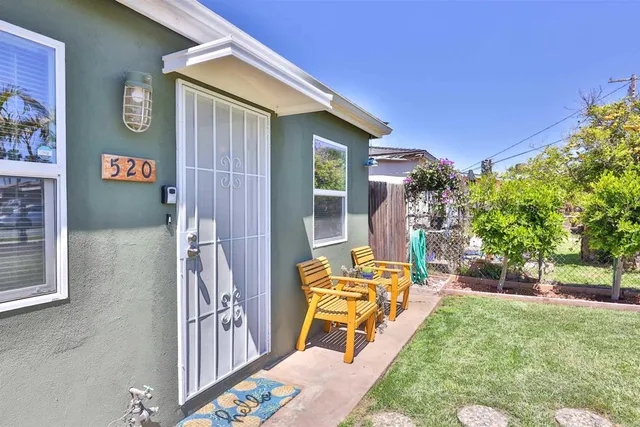 a view of a house with backyard porch and sitting area