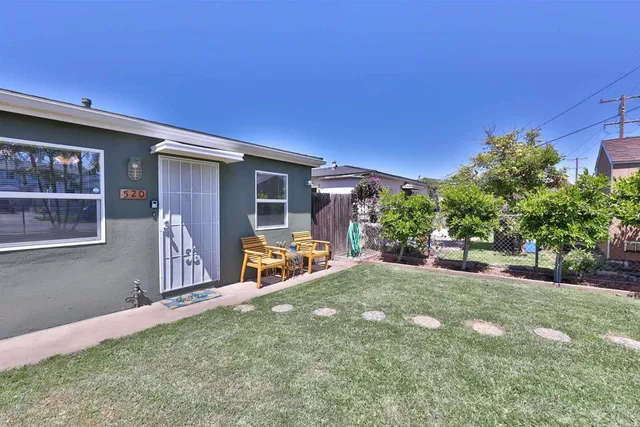a view of a house with backyard and porch