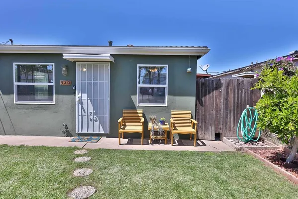a view of a house with backyard porch and front view of a house