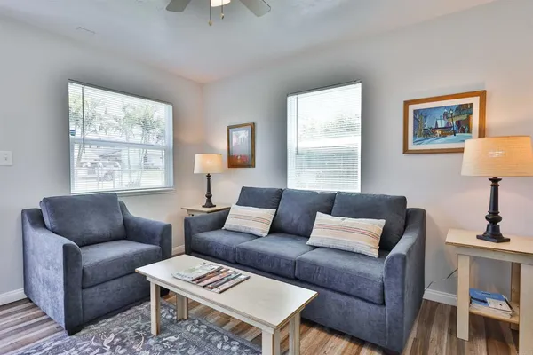 a living room with furniture a couch and a window
