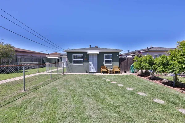 a view of a house with backyard porch and sitting area