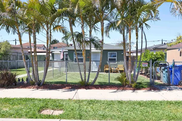 a house with a garden and palm trees