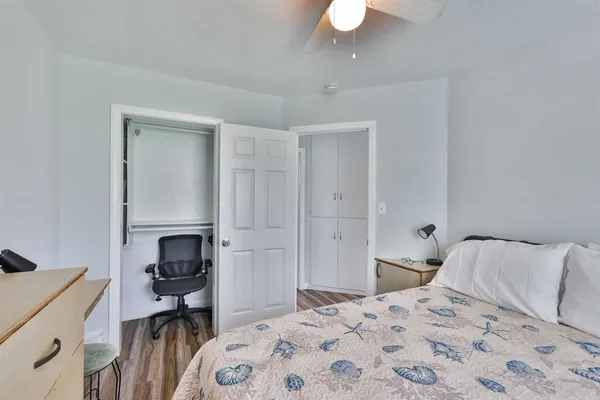 a bedroom with a bed and a chair