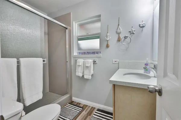 a bathroom with a sink and mirror with toilet
