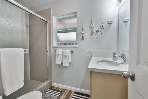 a bathroom with a sink and mirror with toilet