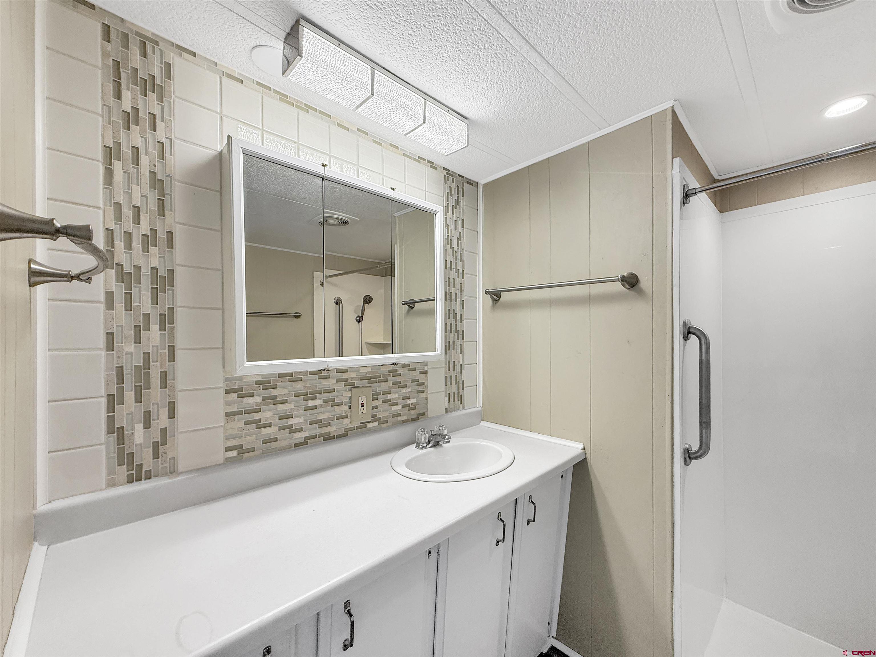 5057 Peach Valley Road Delta, CO 81416 - Photo 17 of 22 a bathroom with a sink and a mirror