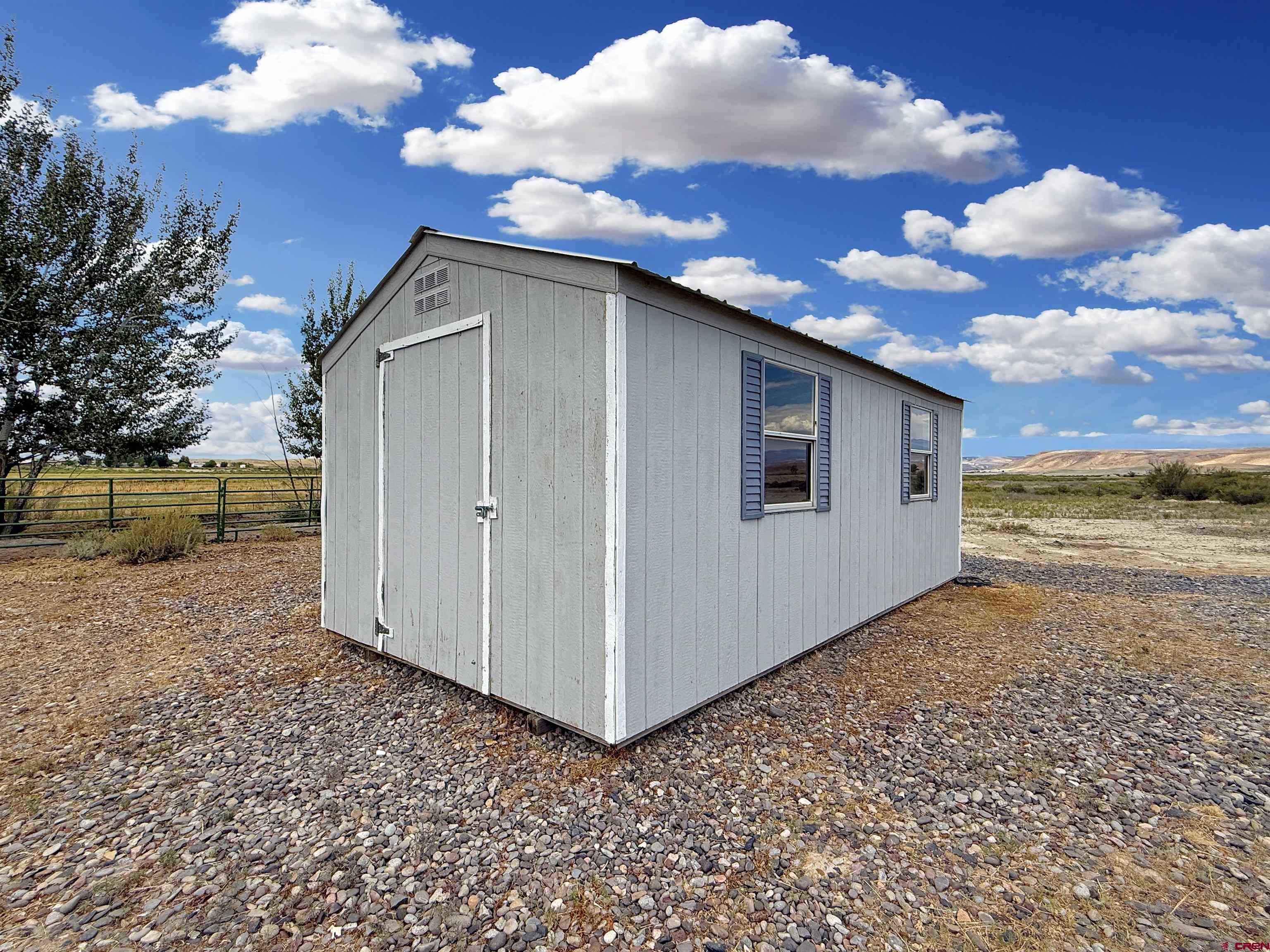 5057 Peach Valley Road Delta, CO 81416 - Photo 21 of 22 a view of a house with backyard
