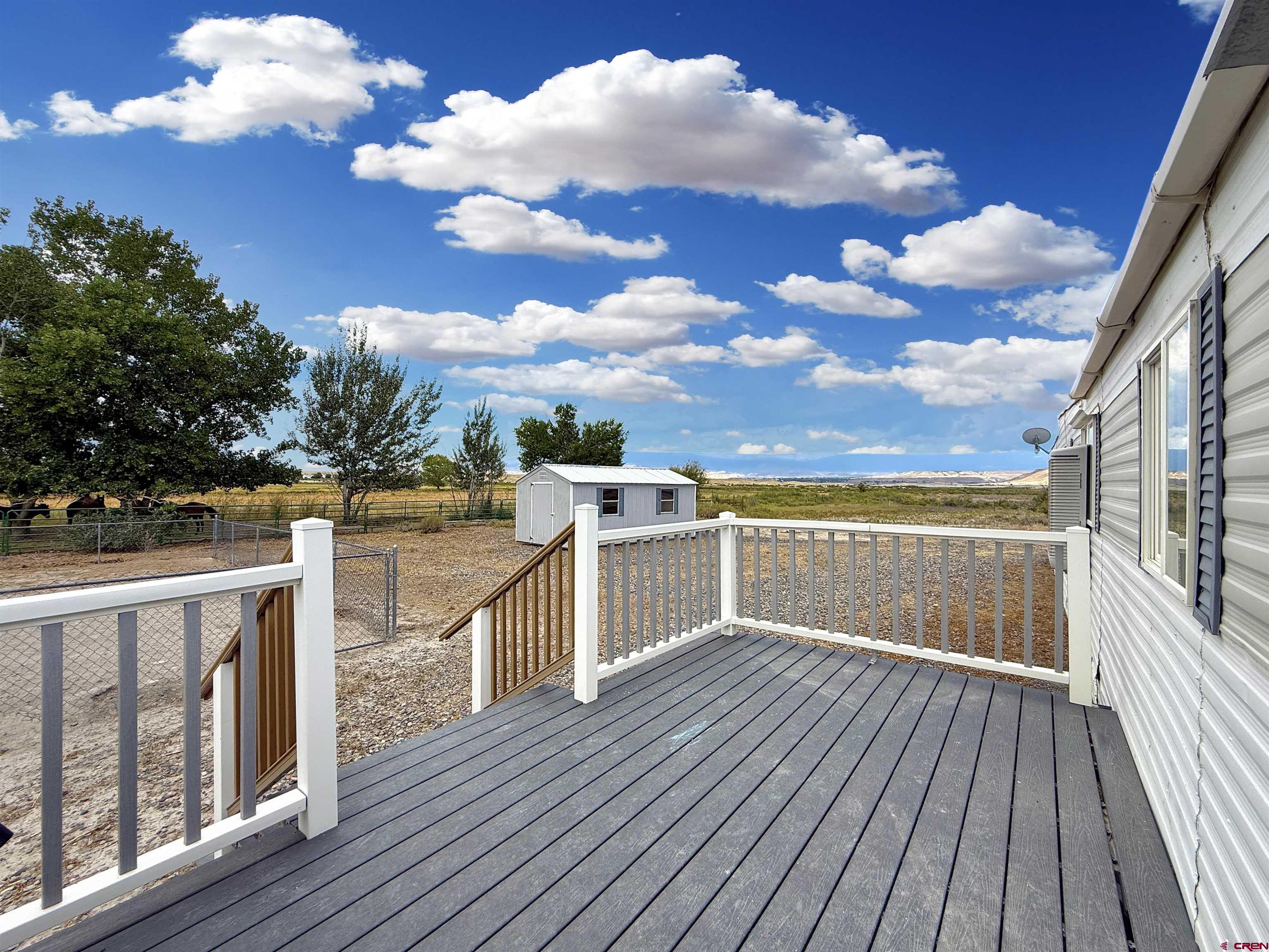 5057 Peach Valley Road Delta, CO 81416 - Photo 4 of 22 a view of a balcony with wooden floor