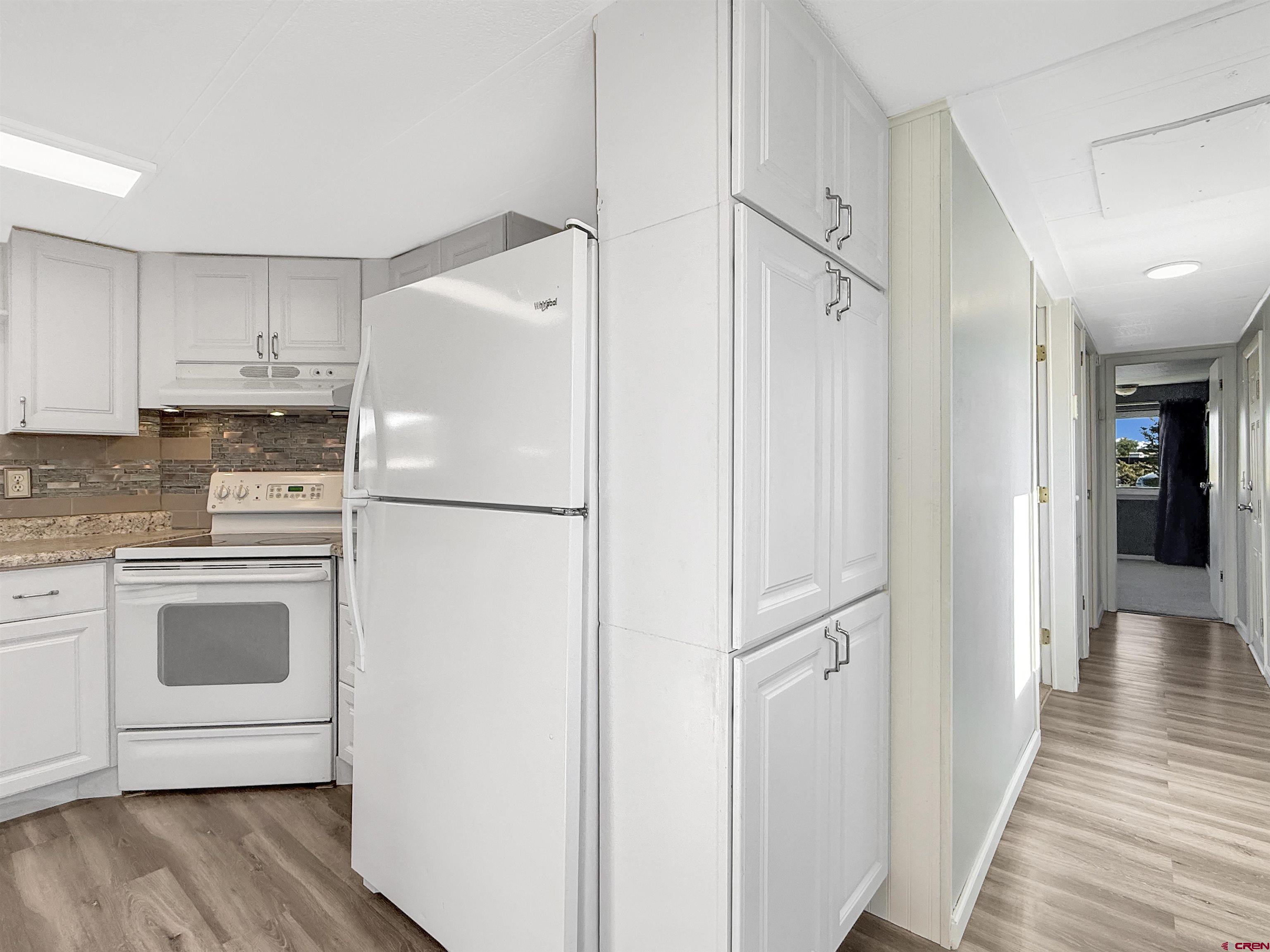 5057 Peach Valley Road Delta, CO 81416 - Photo 9 of 22 a white refrigerator freezer sitting inside of a kitchen