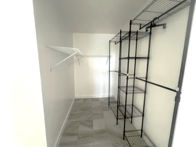 a large kitchen with a sink and cabinets