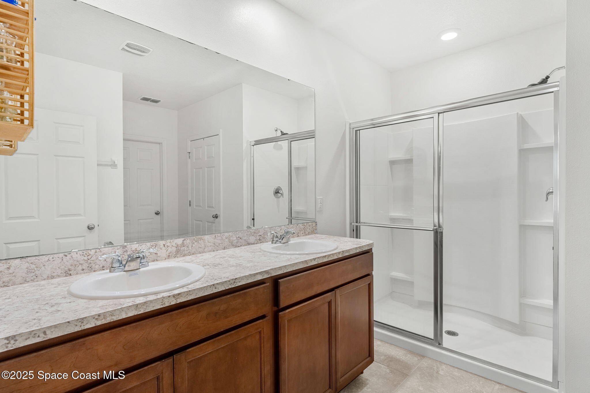 369 Coyote Drive Cocoa, FL 32927 - Photo 14 of 32 Two sinks & a walk-in shower