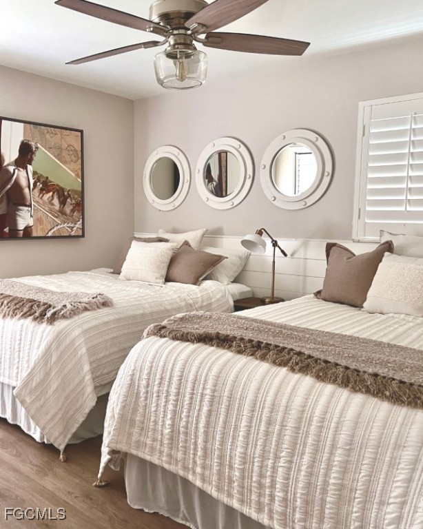 12 Knights Bridge Road, Unit A32 Naples, FL 34112 - Photo 4 of 7 a bedroom with a bed and painting on the wall