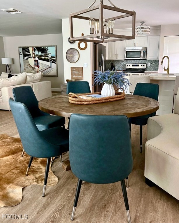 12 Knights Bridge Road, Unit A32 Naples, FL 34112 - Photo 5 of 7 a living room with furniture and a wooden floor