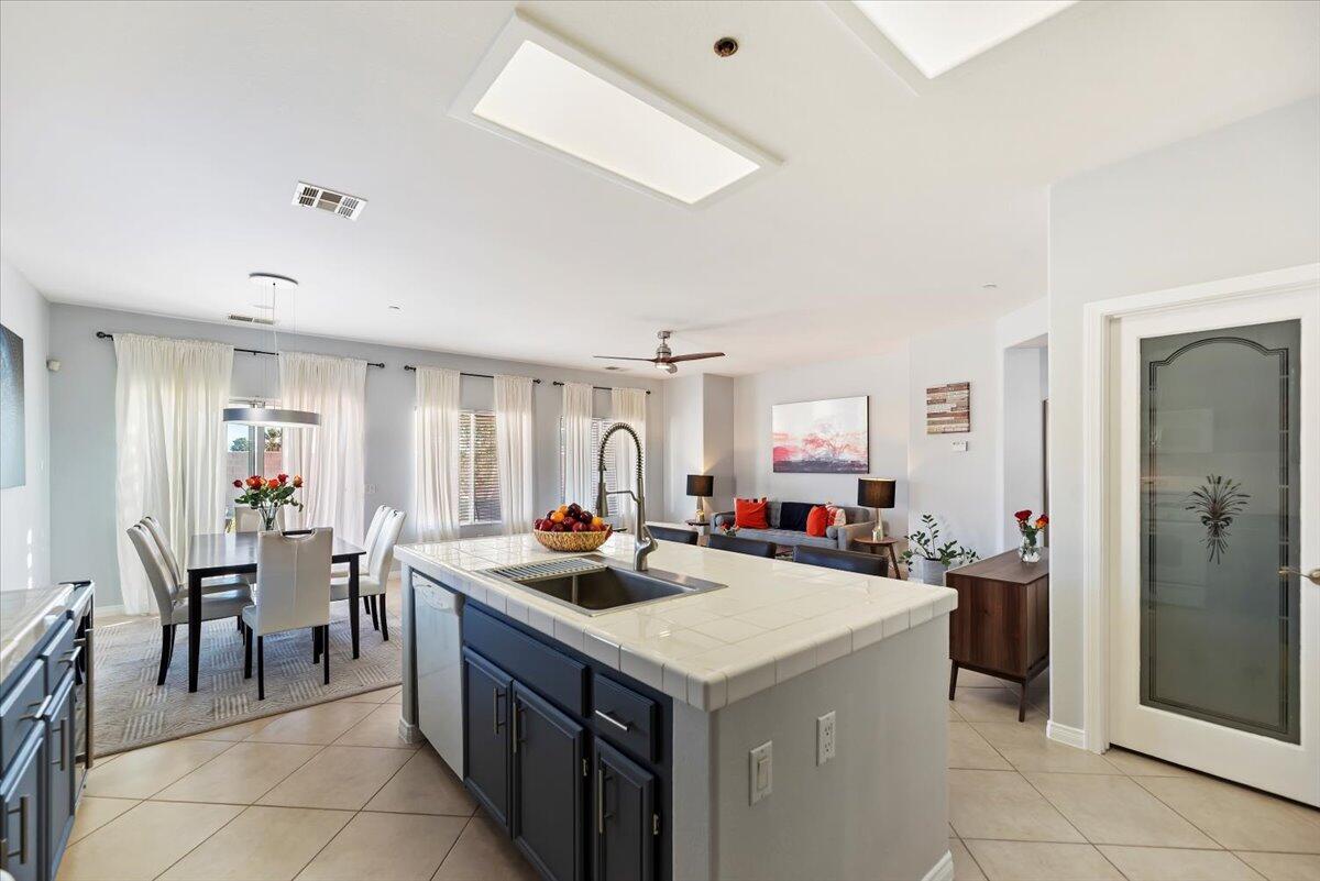 3982 Eastgate N Road Palm Springs, CA 92262 - Photo 12 of 55 a kitchen with a sink a counter and chairs