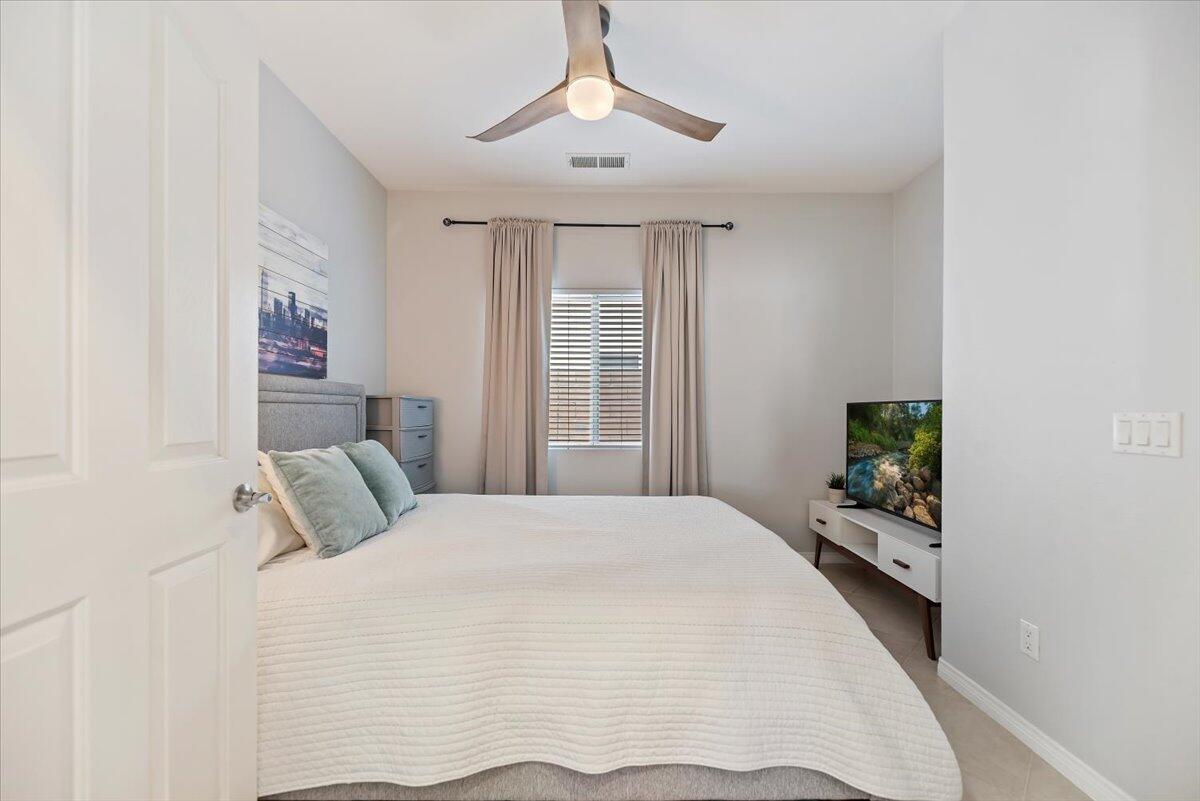 3982 Eastgate N Road Palm Springs, CA 92262 - Photo 17 of 55 a bedroom with a large bed and a chandelier