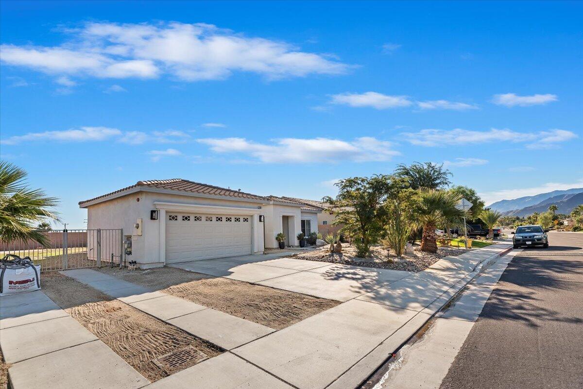 3982 Eastgate N Road Palm Springs, CA 92262 - Photo 37 of 55 a view of a white house with a yard