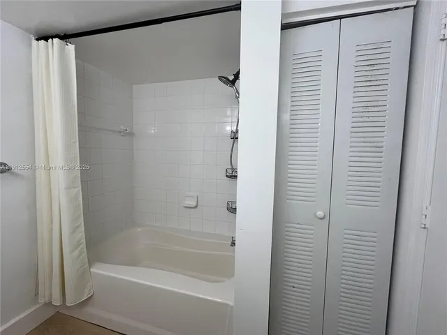 a bathroom with a shower and a bath tub