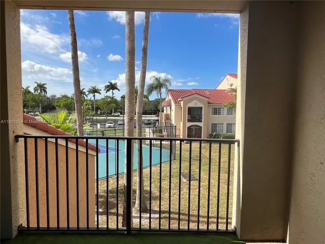 a view of balcony with floor to ceiling window and wooden fence