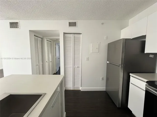 a kitchen with stainless steel appliances a refrigerator and a stove