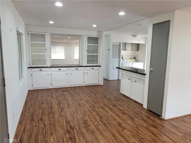 a view of a kitchen with wooden floor