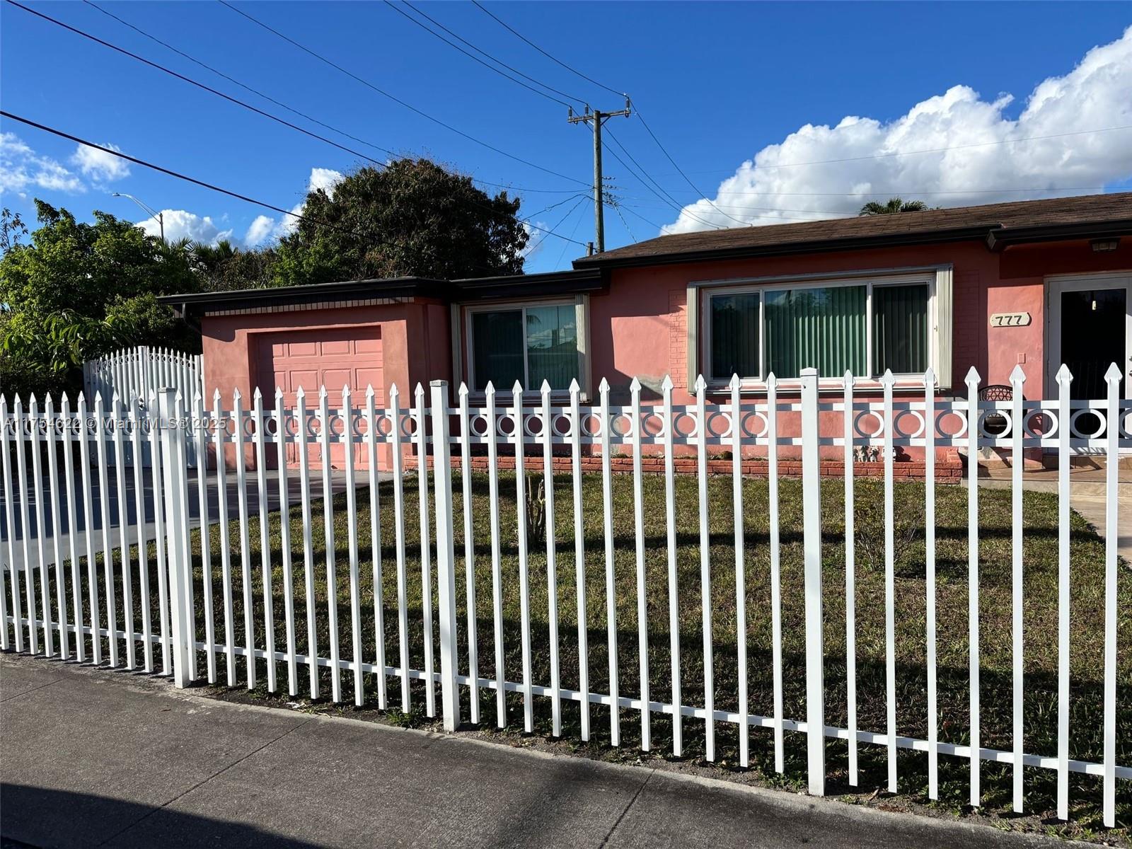 Hialeah Hialeah, FL 33012 - Photo 3 of 7 a front view of a house with a fence