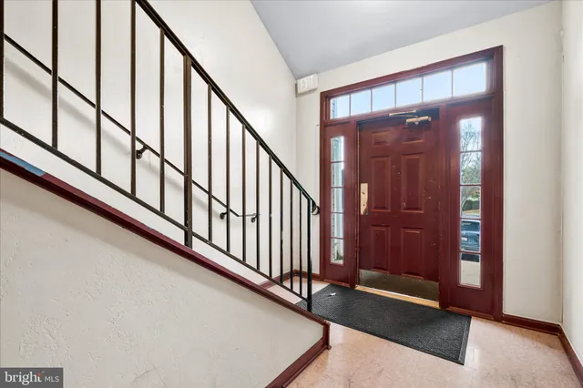 a view of a hallway with entryway door