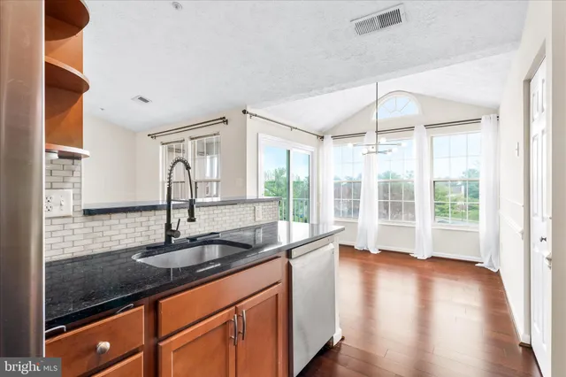 a kitchen with sink and large window