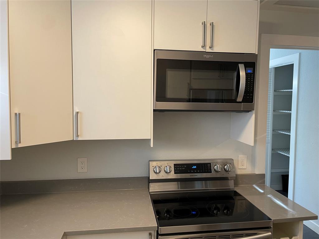 10310 Gail Road, Unit B Austin, TX 78748 - Photo 4 of 12 A well-appointed kitchen features sleek countertops and modern stainless steel appliances.