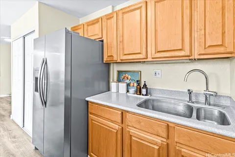 a kitchen with stainless steel appliances granite countertop a refrigerator and a sink
