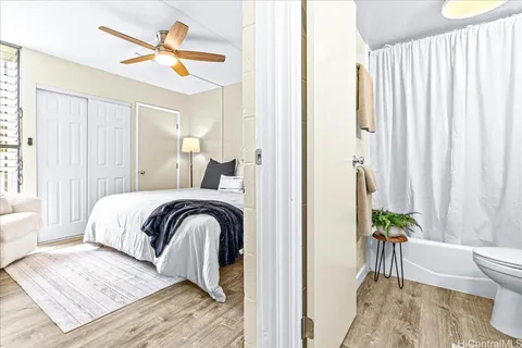 a bedroom with a bed and a painting on the wall