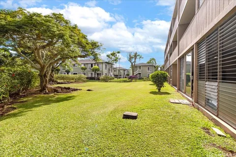 a view of a swimming pool with an outdoor seating and a yard