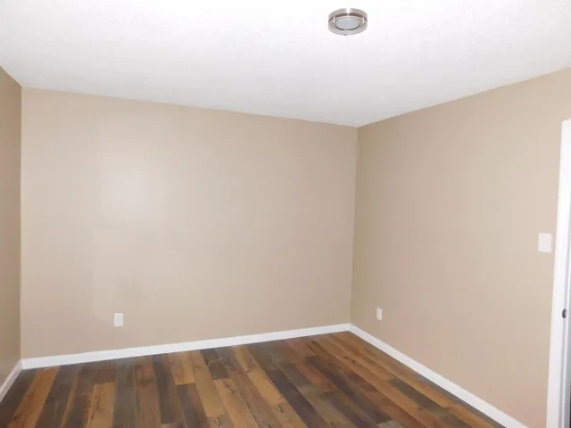 an empty room with wooden floor