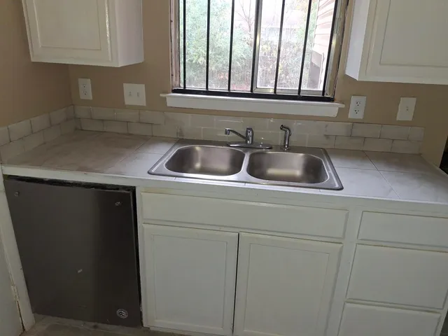 a kitchen with a sink and cabinets