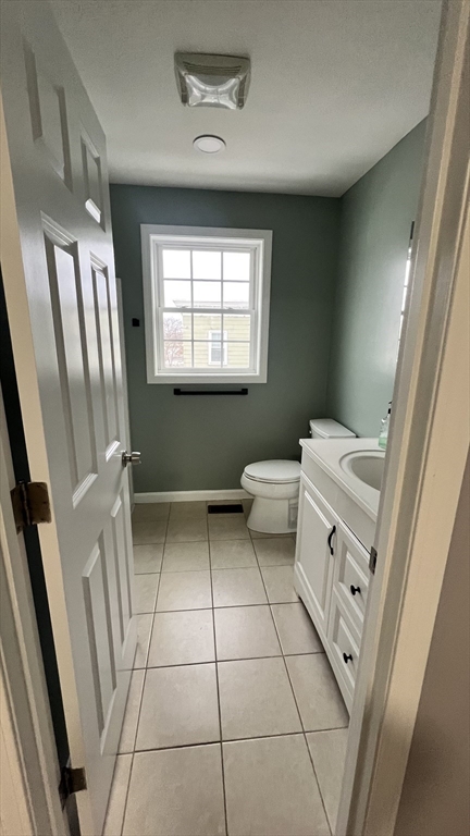 15 Gale Street, Unit 1 Lawrence, MA 01841 - Photo 12 of 25 a bathroom with a toilet sink and mirror
