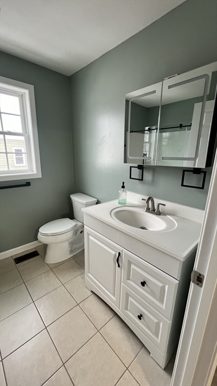 15 Gale Street, Unit 1 Lawrence, MA 01841 - Photo 13 of 25 a bathroom with a sink a toilet and mirror