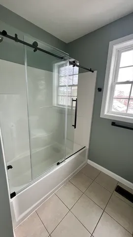 a bathroom with a bathtub and a shower