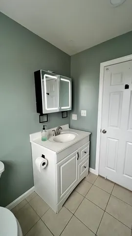 a bathroom with a toilet sink and mirror