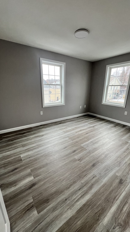 15 Gale Street, Unit 1 Lawrence, MA 01841 - Photo 21 of 25 a view of an empty room with wooden floor and a window