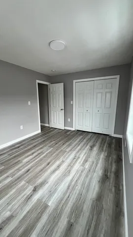 an empty room with wooden floor