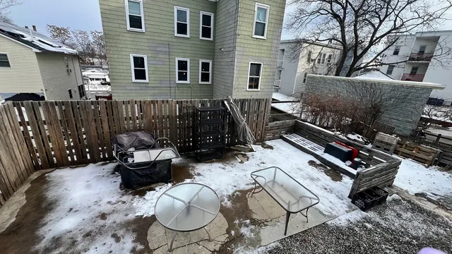 a backyard of a house with fire pit and outdoor seating