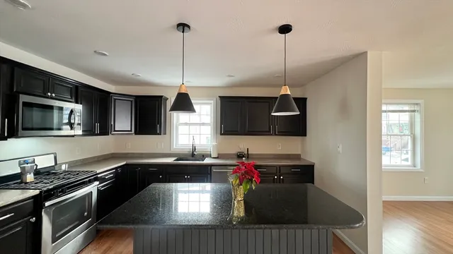 a kitchen with a sink stove and microwave