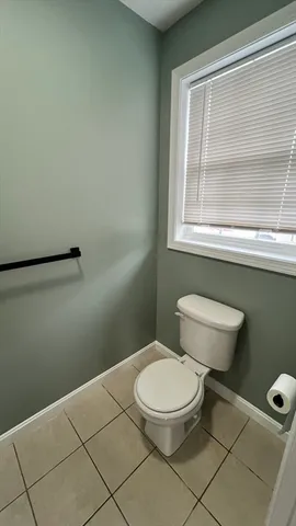 a white toilet sitting next to a bathroom sink