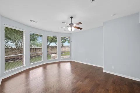 a view of room with window and ceiling fan