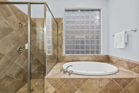 a bath tub sitting next to a shower
